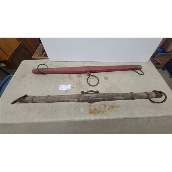 Two Wood and Iron Yokes: One Natural Finish, One Red Painted