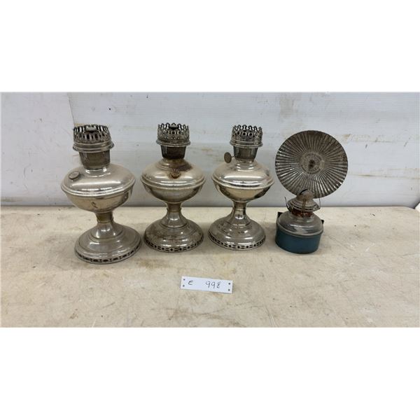 Three Antique Silver-Tone Metal Oil Lamps and Bracket-Mounted Kerosene Lamp With Fluted Reflector