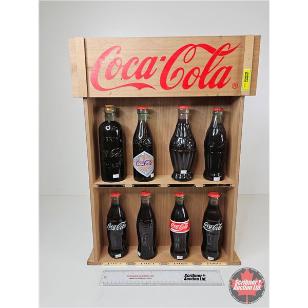 Coca-Cola Full Scale Replica Coke Bottles (8) : Key Dates (1899-1991) c/w Haning or Counter Top Shel