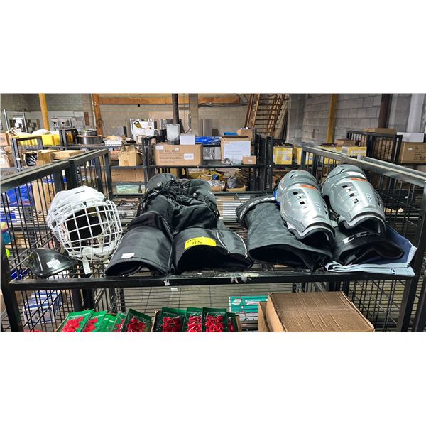 SHELF OF ASSORTED HOCKEY GEARS INCL. HELMET SHIN GUARDS, PANTS AND MORE
