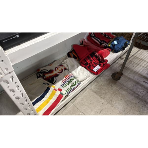 SHELF OF ASSORTED BLANKETS