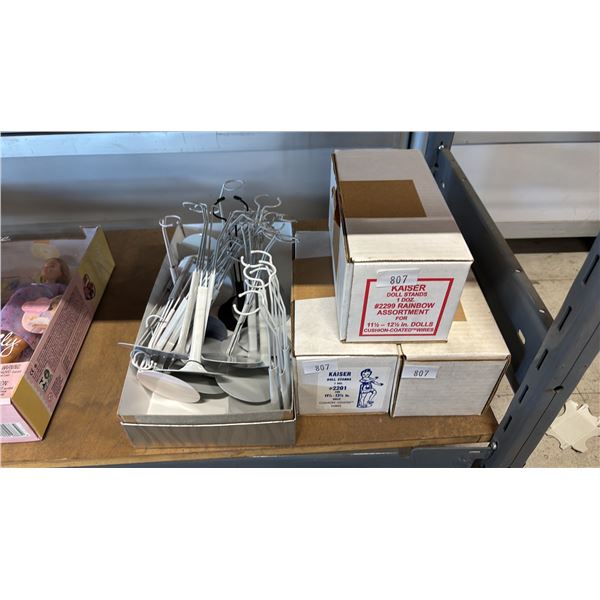 4 BOXES OF METAL DOLL STANDS