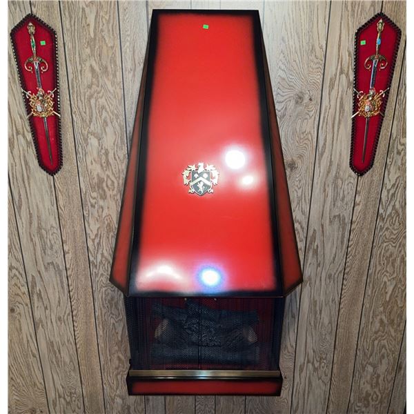 Wall-Mounted Red Metal Fireplace with Decorative Crest and Matching Sword Plaques