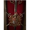 Image 9 : Wall-Mounted Red Metal Fireplace with Decorative Crest and Matching Sword Plaques