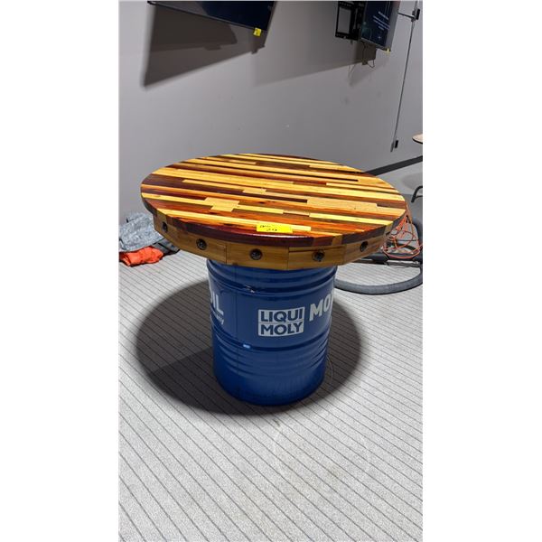 39" DIAMETER WOODEN TABLE TOP ON BLUE 50 GALLON OIL DRUM - APPROX. 3FT HIGH
