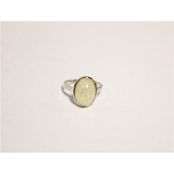 13)  SILVER TONE, BEZEL SET OVAL CREAMY