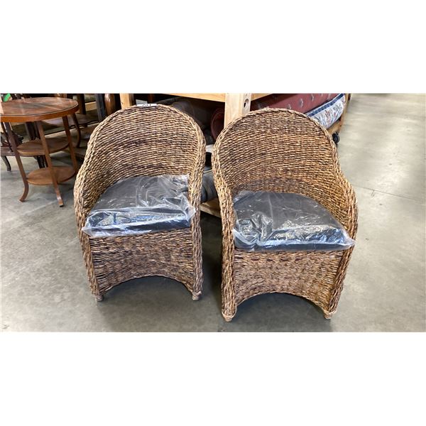 PAIR OF WOVEN RATTAN CHAIRS WITH BLACK UPHOLSTERED CUSHIONS