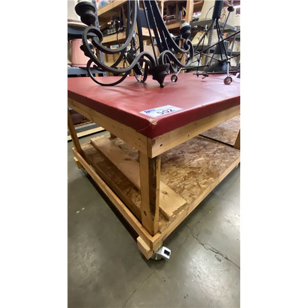 RED VINYL COVERED TOP LARGE MOBILE WOODEN WORK TABLE - APPROX. 8FT X 4FT X 3FT HIGH