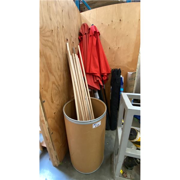 GROUP OF 7 ASSORTED PATIO UMBRELLAS AND BARREL OF WOODEN POLES