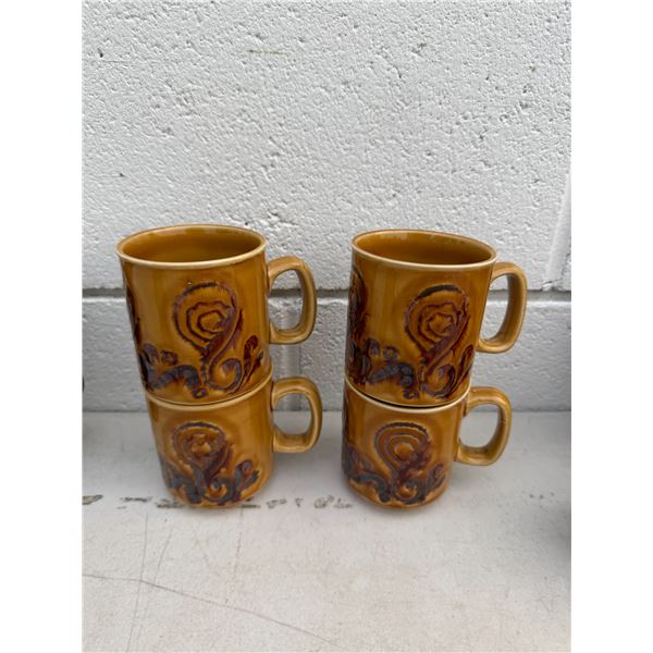 vintage 1970s WP England stoneware mugs featuring a rich amber-ochre glaze and a dark brown embossed