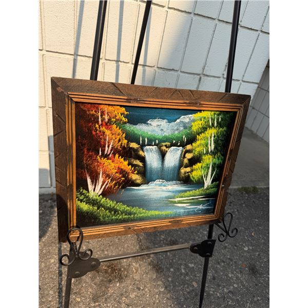 vibrant vintage mid-century velvet waterfall landscape painting is set in a rustic hand-carved woode