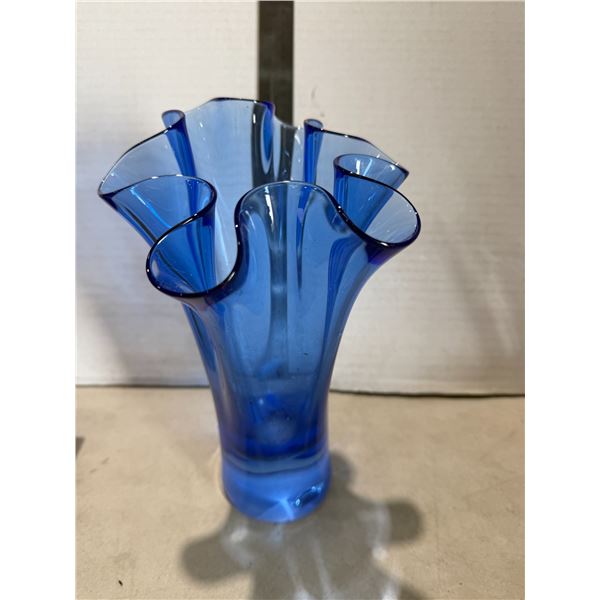 Riffled edge, blue glass vase bottom has chip