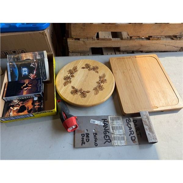 Lazy suite, Susan, cutting board, VHS movies, dartboard hanger and energizer flashlight