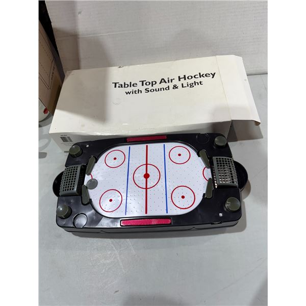 Tabletop air hockey with sound and light