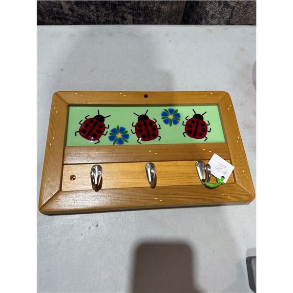 Wooden key holder with porcelain ladybug panel
