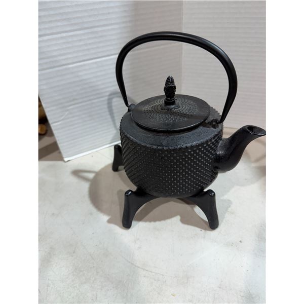 Cast-iron kettle on stand