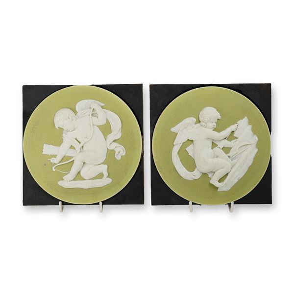 A Pair of Wedgwood Green and White Jasperware Round Plaques Depicting Cupids