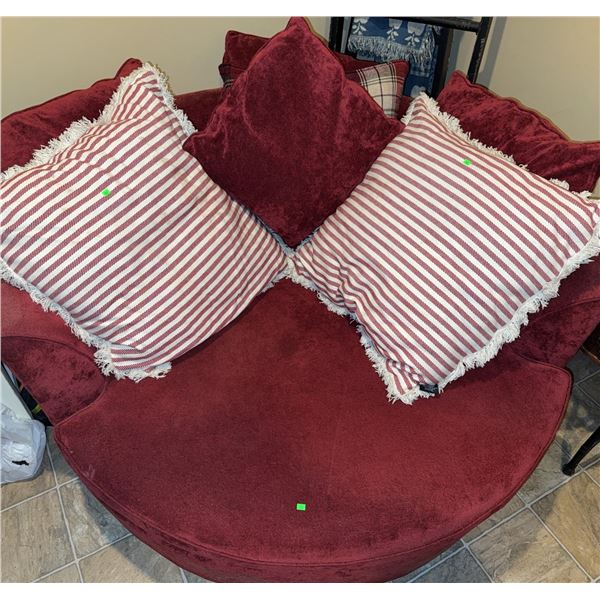 Round Upholstered Swivel Chair with Red Fabric and Accent Pillows