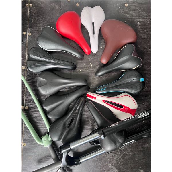 11 Mixed Bicycle Saddles and 2 Fork Assemblies, Including RockShox Tora