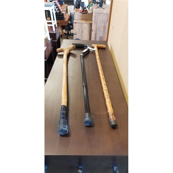 3 WALKING CANES. 2 WOODEN AND 1 PLASTIC