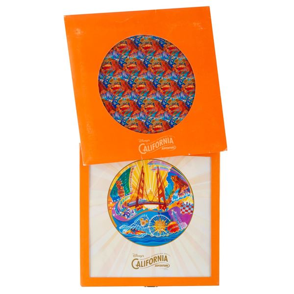A Disney’s California Adventure Inaugural Celebration Plate and Scarf.