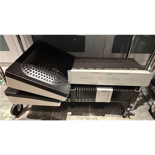 Group of AJA Io Video Interface, Rotel Eight Channel Power Amplifier, and Speaker Enclosures