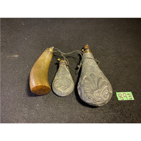 Collection of antique powder horns and flasks traditionally used for gunpower