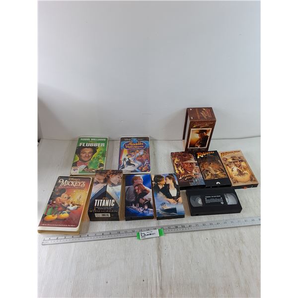 (10) VHS Tapes, Indiana Jones Trilogy, Titanic, Mickey's Christmas, Aladdin, Flintstones, Pokémon