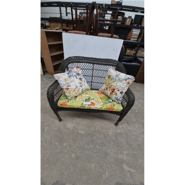 Wicker Loveseat with Tropical Print Seat Cushion and Two Floral Throw Pillows
