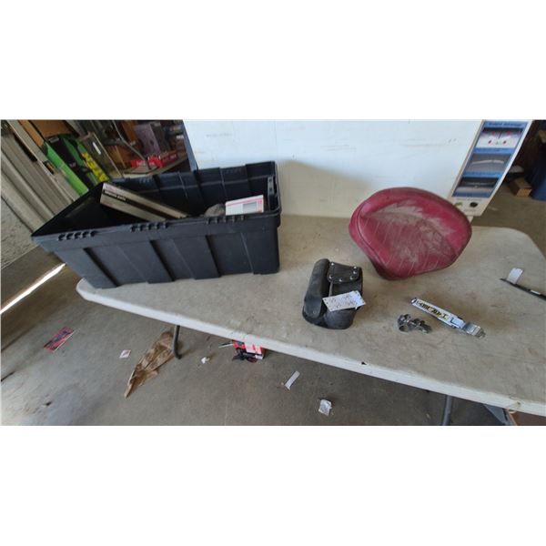 Harley-Davidson Motorcycle Seat, Tool Bag, and Engine Parts in Storage Bin