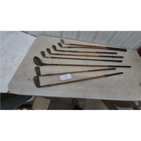 Collection of 9 Antique Golf Clubs: 1 Wood Driver, 8 Iron Clubs