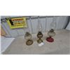 Image 1 : Three Oil Lamps: 1 Brass Base and Clear Glass Font, 1 Brass Base and Clear Glass Font, 1 Red Base.