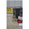 Image 4 : Three Oil Lamps: Clear Glass, Red and White Glass, and Frosted Glass