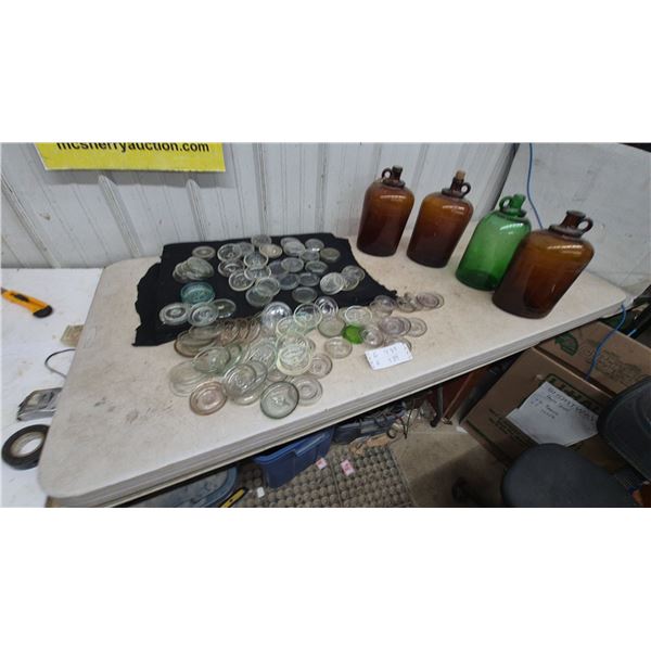 Assorted Glass Jar Lids and 4 Glass jugs: 2 Amber, 1 Green, 1 Brown