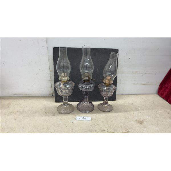 Three Vintage Sun-Purpled Pressed Glass Kerosene Oil Lamps With Chimneys and Brass Burners