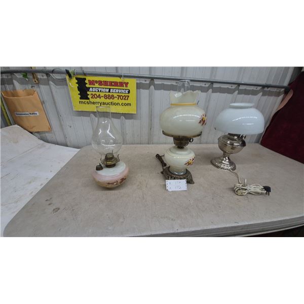 Three Oil Lamps: Clear Glass and Pink Base, Floral Painted White, and Silver Tone and White