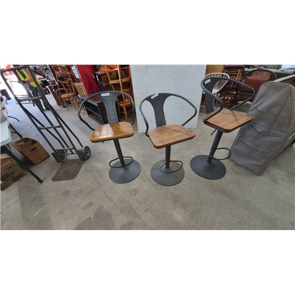 Three Industrial Style Swivel Bar Stools with Wood Seats and Metal Frames