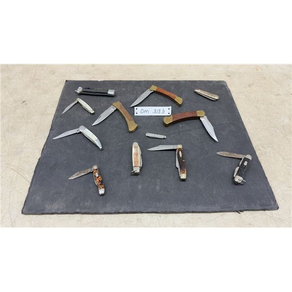 Assortment of Vintage Folding Pocket Knives Including Case XX Trapper and Buck 110-Style Lockbacks
