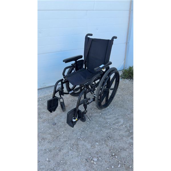 Quickie Manual Wheelchair with Swing-Away Footrests and Seatbelt