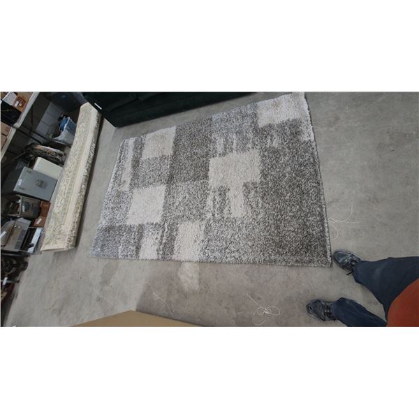 Shag Area Rug with Block Pattern and Green Sofa