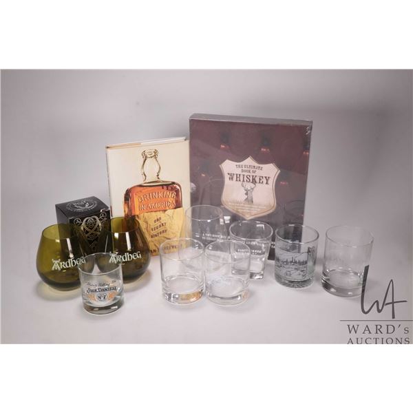 Six empty collectible liquor bottles and a two boxed book set "The Ultimate Book of Whiskey"