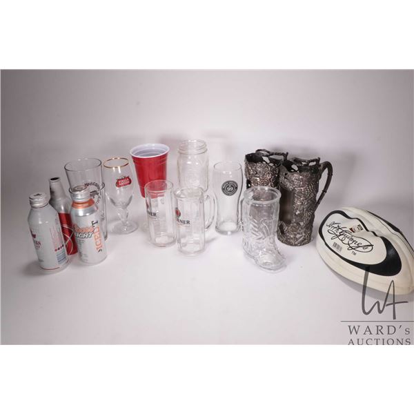 Selection of branded beer glasses and mugs plus two empty beer cans and a deflated football etc.