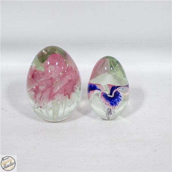 2 GLASS EGG PAPERWEIGHTS. ONE IS GLASS EYE STUDIO