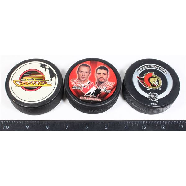 CANADIAN TEAM HOCKEY PUCKS SENS CANUCKS
