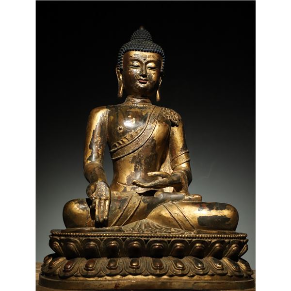 A MING DYNASTY STATUE OF SAKYAMUNI BUDDHA
