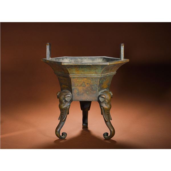 A BRONZE HEXAGONAL ELEPHANT-FOOTED EAR-SHAPED FURNACE FROM THE QING DYNASTY'S QIANLONG PERIOD