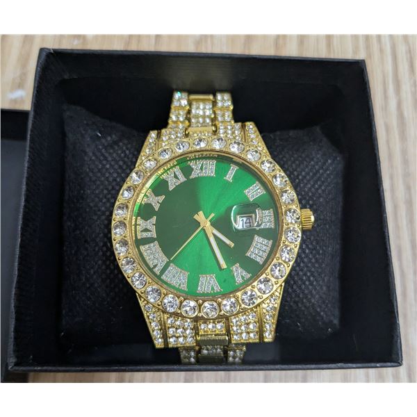 Gold tone watch, green face