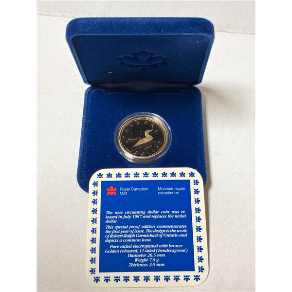 1987 Proof Loonie Dollar. The first year of the Loonie. Proof with Ultra Heavy Cameo. Housed in its 