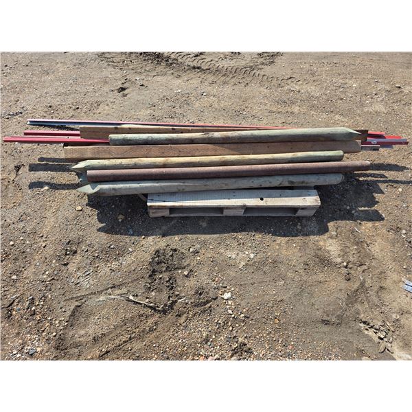 Pallet of treated wooden posts and trim- posts are 6ft L