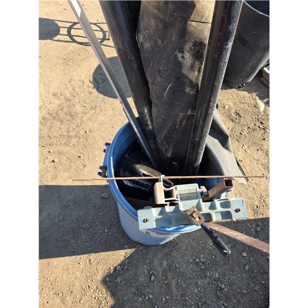 Garbage can full of misc items- piping, saw guild